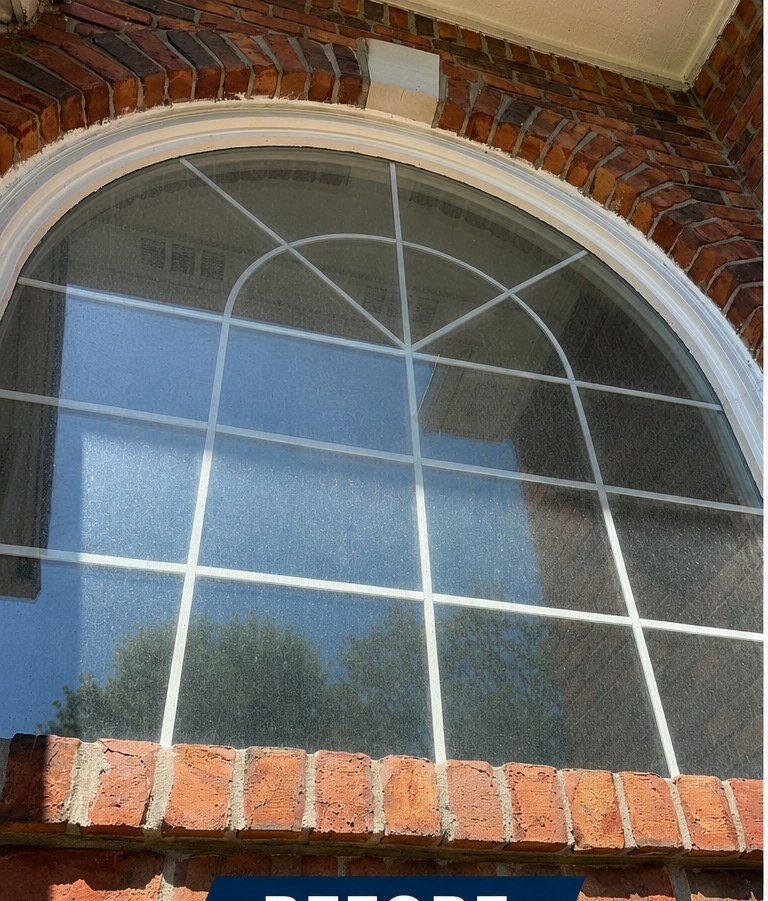 Dirty exterior window with hard-water spots before Apex Exteriors clean